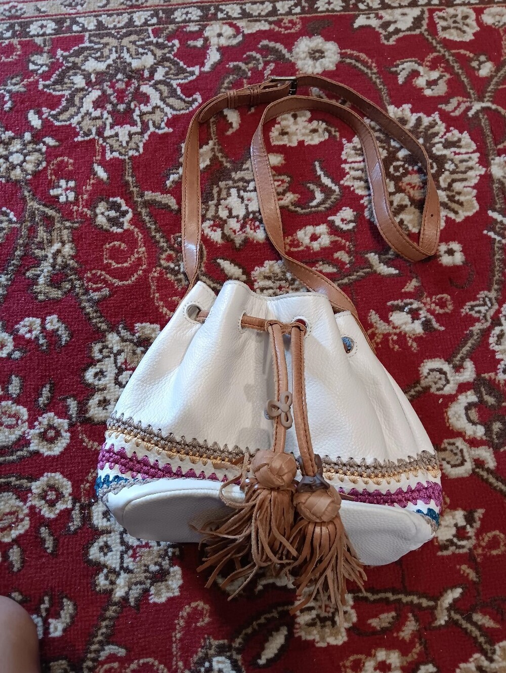 The Sak White Leather Drawstring Bucket Shoulder Bag with Tan Tassels